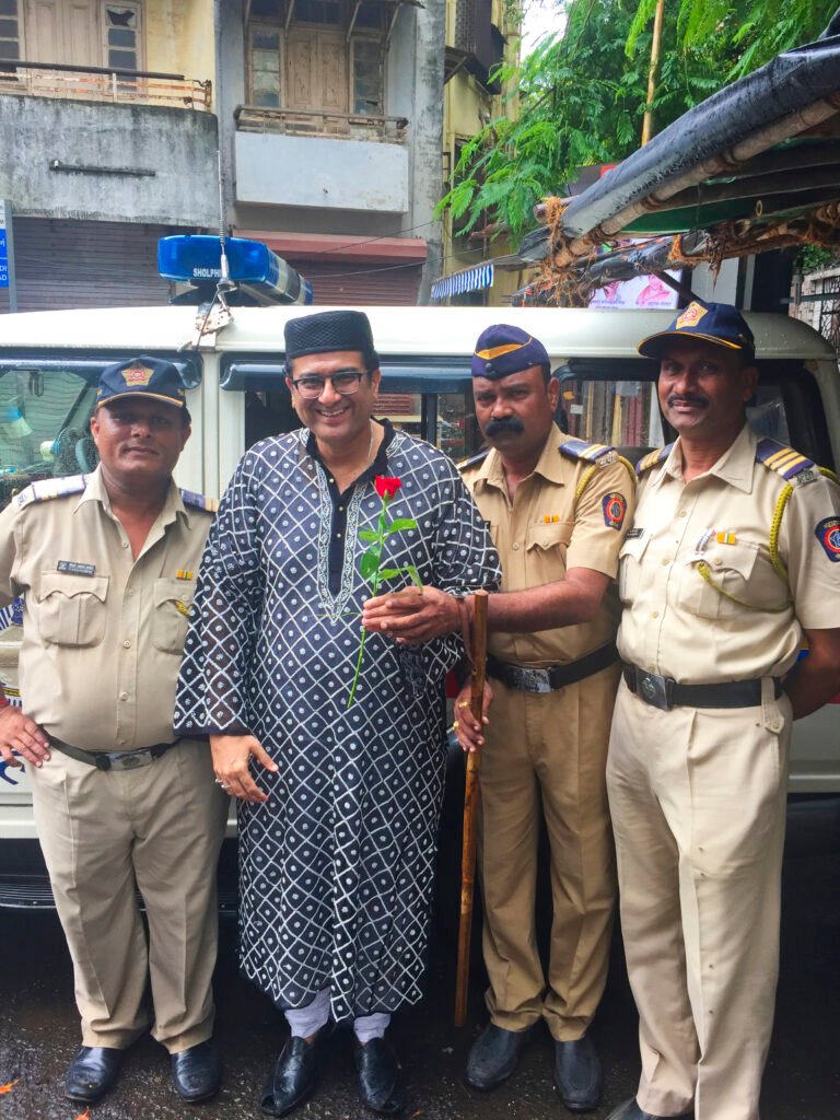 Eid morning in Mumbai — Humayunn Peerzaada with Mumbai Police after Eid namaaz, receiving a rose as a symbol of peace, harmony, and unity.