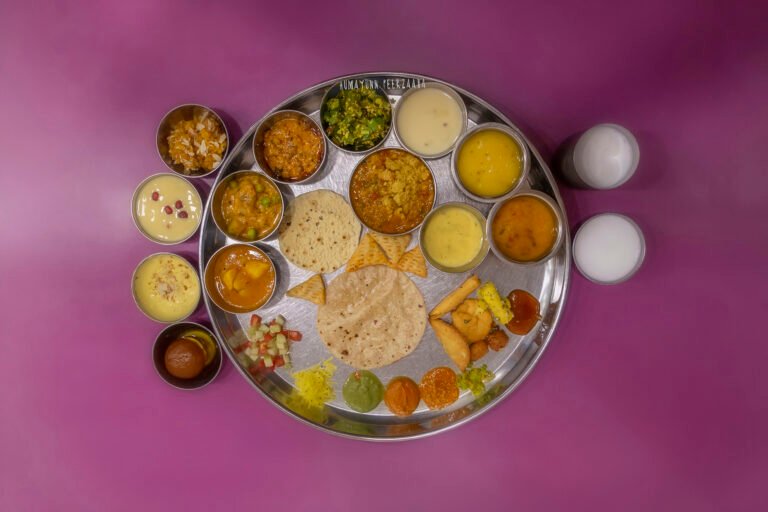 Traditional Gujarati thali served at Shree Thaker Bhojanalay, Mumbai — featuring an array of authentic dishes, vegetables, dals, farsan, sweets, and accompaniments.
