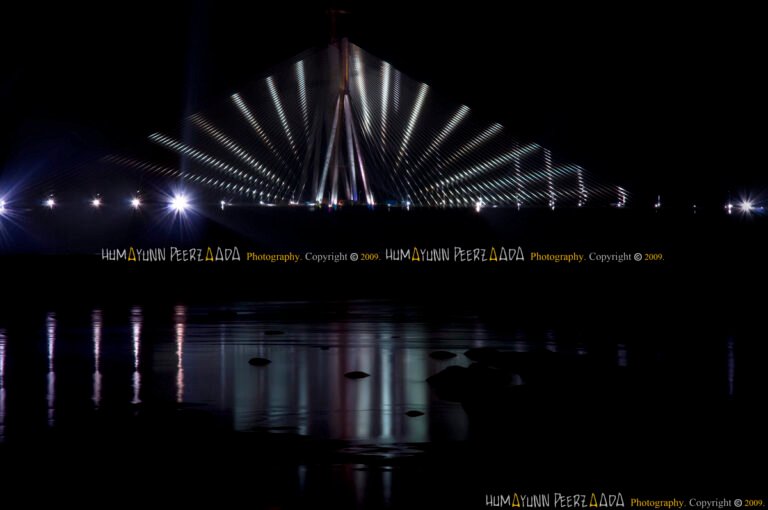 Bandra-Worli Sea Link illuminated at night, its dazzling lights reflecting over the Arabian Sea — photographed by Humayunn Peerzaada.