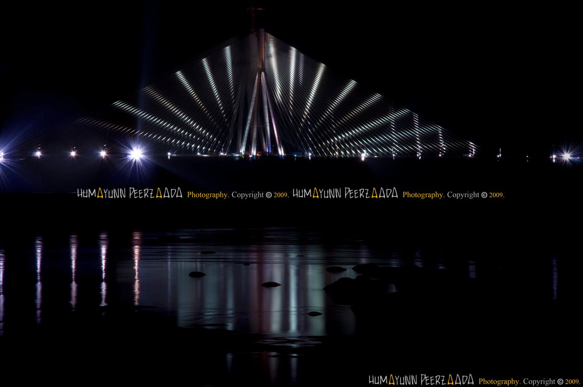 Bandra-Worli Sea Link illuminated at night, its dazzling lights reflecting over the Arabian Sea — photographed by Humayunn Peerzaada.