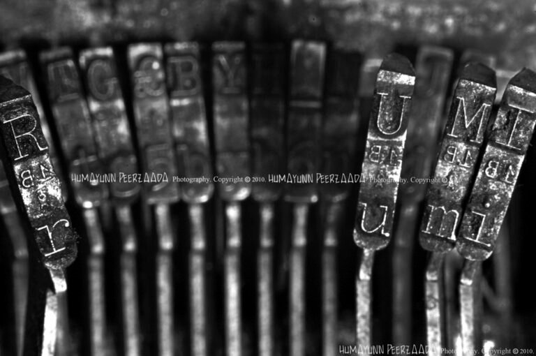 Close-up of vintage typewriter keys spelling out “Rumi,” symbolizing inspirations drawn from the poet’s timeless words.