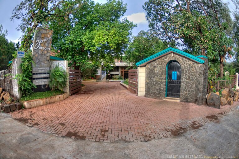 Entrance of Zara’s Resort in Khandala, featuring stone architecture, lush greenery, and a peaceful driveway that creates a welcoming ambiance.