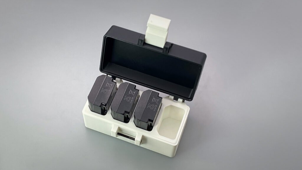Sony NP-FZ100 battery storage case holding multiple camera batteries in a compact organizer box for travel and safe storage.