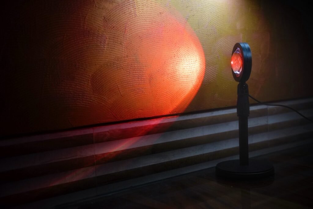 Warm sunset lamp casting a cinematic glow on a textured wall — perfect ambient lighting setup for reels, portraits, and indoor photography.