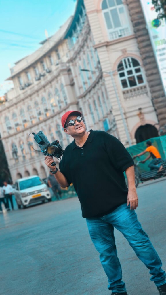 Man holding a Sony camera standing on a street in Mumbai, expressing a deep bond with photography