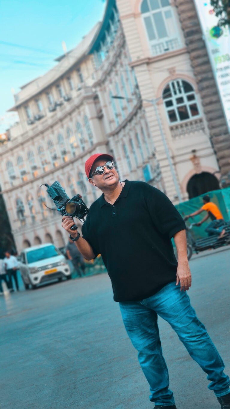 Photographer standing with camera in Mumbai street, symbolizing a lifelong connection with photography