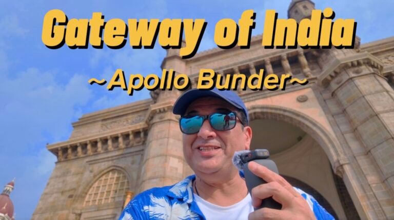 Humayun Peerzaada standing in front of the Gateway of India at Apollo Bunder, Mumbai during a cinematic travel vlog shoot.