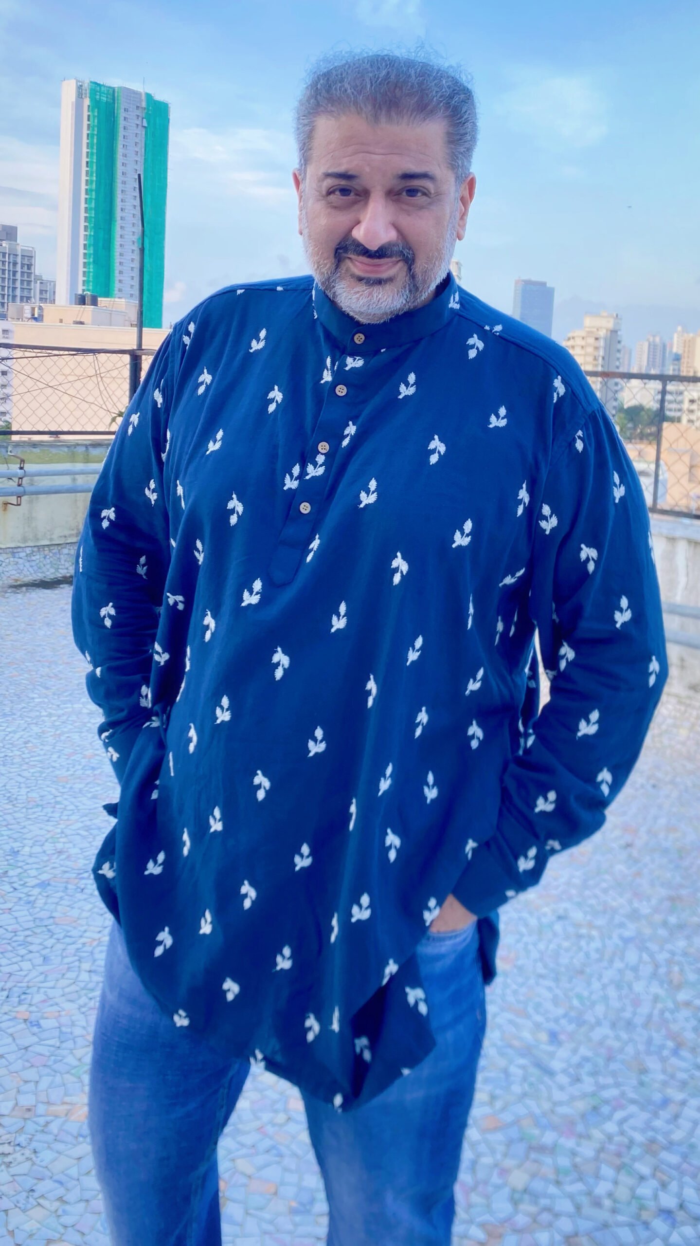 A simple and elegant ethnic look featuring a blue printed kurta, paired with jeans for a relaxed and effortless style. Photographed on a Mumbai rooftop.