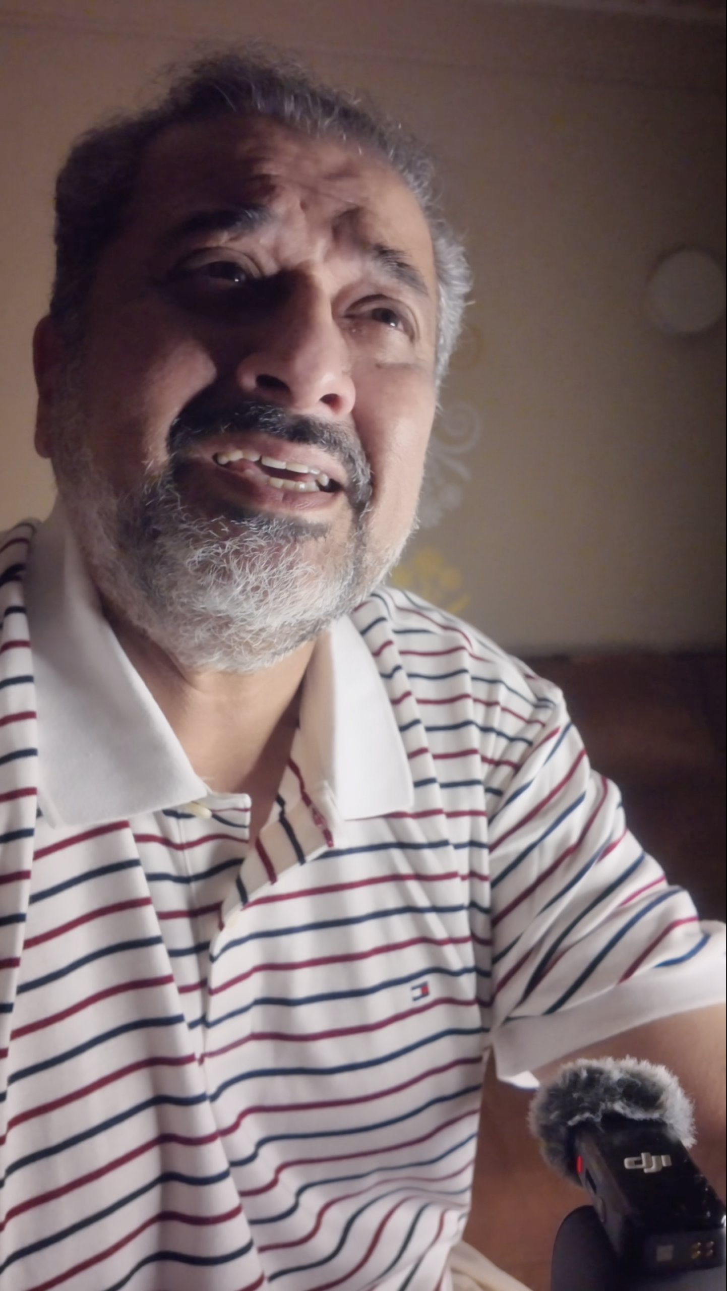 Humayun Peerzaada smiling while holding a microphone, singing a Hindi song